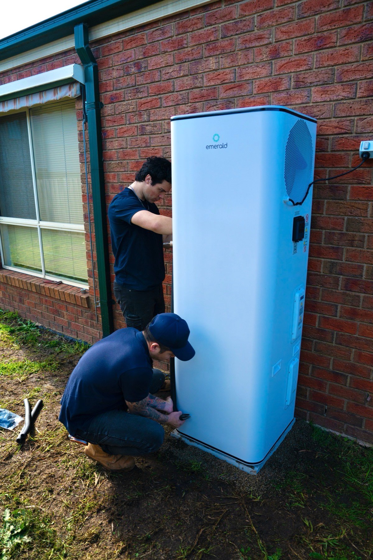 Technicians installing Emerald heat pump